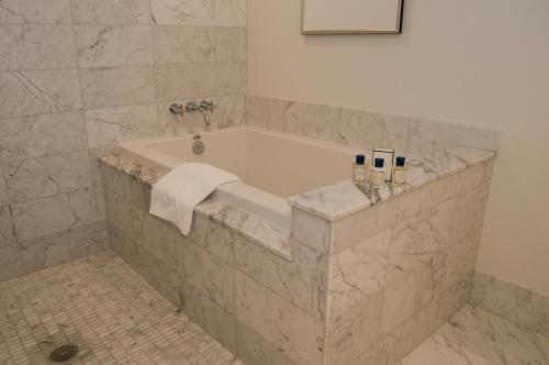 a bathroom with a tub with a towel on it at Jet Luxury Private Residences in Waikiki in Honolulu