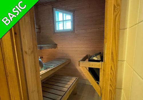 a room with two bunk beds and a window at Camping Nilimella in Sodankylä