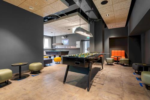 a room with a foosball table and chairs at a&o Copenhagen Sydhavn in Copenhagen