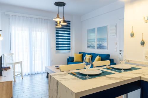a kitchen and living room with a blue couch at Elvis Nest in Nea Moudania