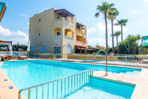 a large swimming pool in front of a building at Thalassa Apartments in Kissamos