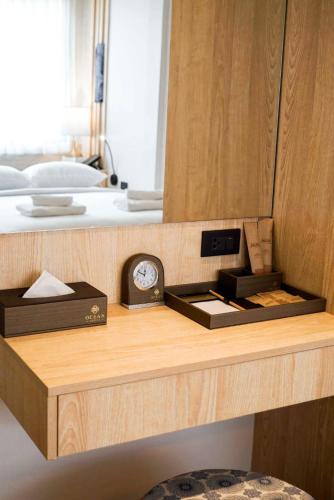 a wooden shelf with a clock on top of a bed at NORN Nimman13 Boutique Hotel Chiang Mai in Chiang Mai