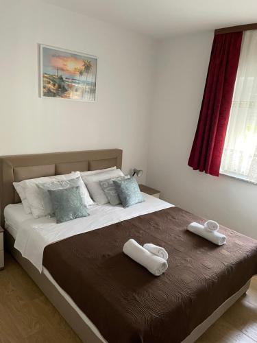sypialnia z dużym łóżkiem z dwoma ręcznikami w obiekcie Apartmani Mirela w Krku