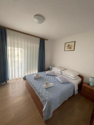 a bedroom with a bed with two towels on it at Apartmani Mirela in Krk