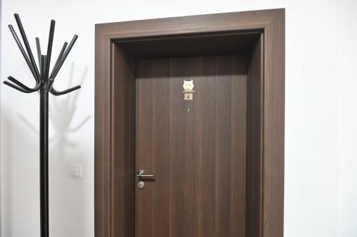 a wooden elevator door with a sign on it at Apartment White Bear in Zlatibor