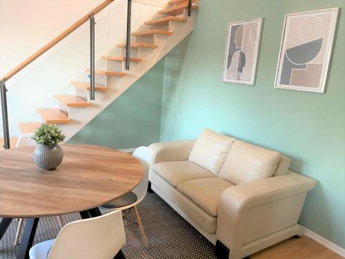 a living room with a couch and a table at Charming Central Apartments in Baden-Baden