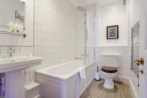 a white bathroom with a sink and a toilet at Bel and The Dragon at Red Lion Wendover in Wendover