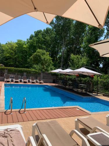a swimming pool with chairs and umbrellas at Park and pool family room in Nesebar