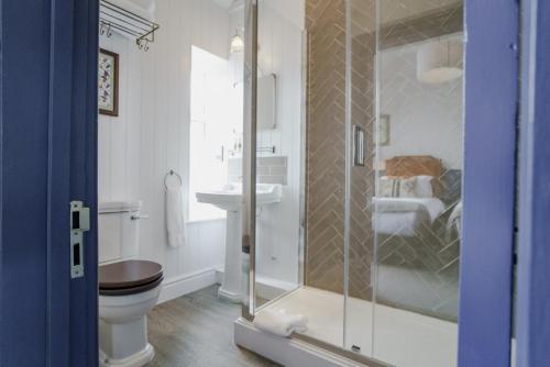a bathroom with a shower and a toilet and a sink at Bel and The Dragon at Red Lion Wendover in Wendover