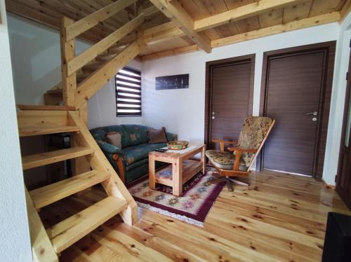 a living room with a staircase and a couch at Apartment Winter Star in Kolašin