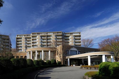 a large apartment building with a street in front of it at Hotel Village Izukogen in Ito