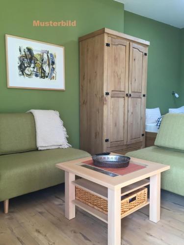 a living room with a couch and a table at Hof Uhleck am Königsstuhl in Lohme