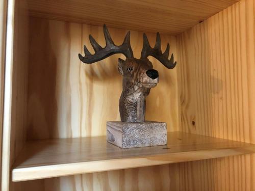 a statue of a deer head on a shelf at Cadras in Tinzen
