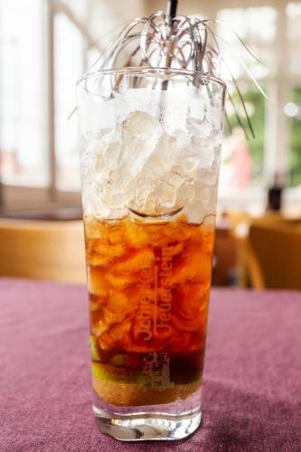 a glass of iced tea sitting on a table at Altora Eisenbahn Themenhotel in Wernigerode
