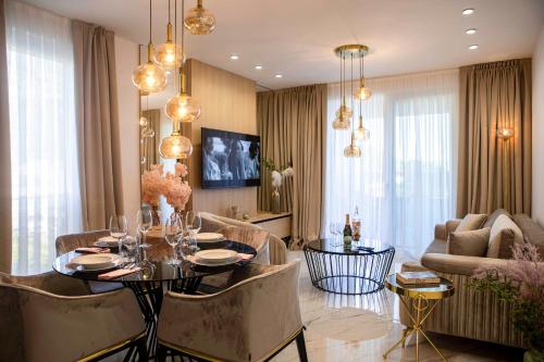 a living room with a table and chairs and a couch at Villa Nina - Apartments with pool near the sea in Rabac