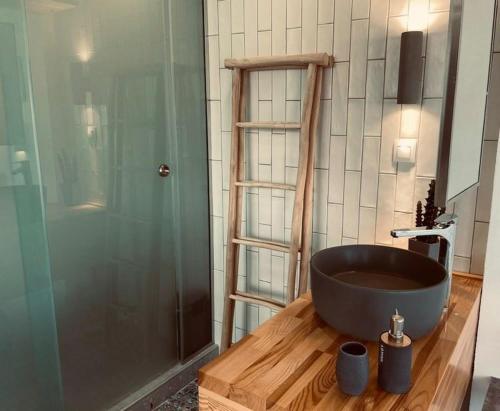a bathroom with a bath tub on a wooden floor at Marika Studios & Apartments in Georgioupolis