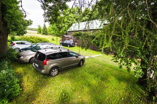 a row of parked cars parked in a yard at Chata Anton Günther in Boží Dar