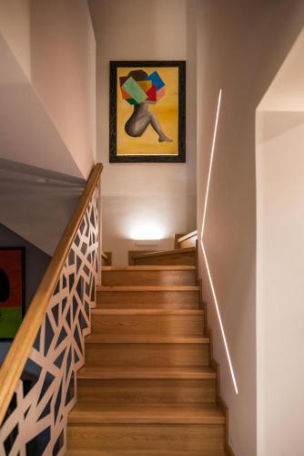 a staircase in a house with a painting on the wall at River Villas Parga in Parga