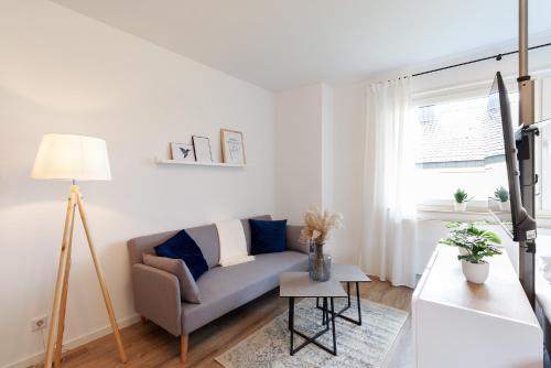 a living room with a couch and a table at Modernes Apartment *Liobablick Nr. 3* - FeWo Fulda/Petersberg in Petersberg