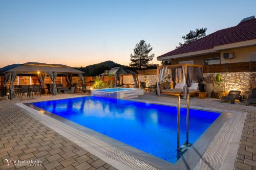 a swimming pool in the backyard of a house at Panthea Luxury Villa in Ialysos