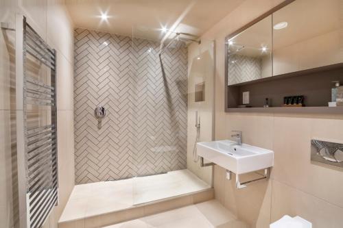 a bathroom with a sink and a shower at City Apartments - Hudson Quarter in York
