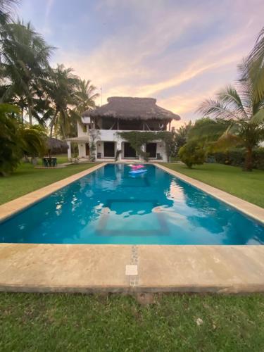 a swimming pool in front of a house at Casa Maya private villa on the beach in Puerto Escondido