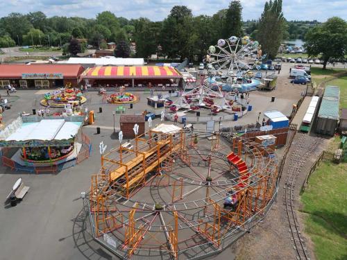 an amusement park with a roller coaster and a carnival at Impeccable 3 bedroom lodge pet friendly in Northampton