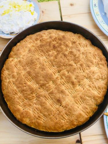 a pie sitting in a pan on a table at Guest House Qafe Dardha - Tomorr National Park in Dardhë