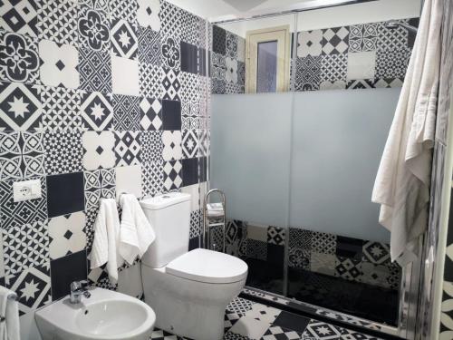 a bathroom with a toilet and a sink at Suite On Fish Market in Catania