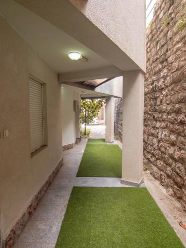 an empty hallway with green grass in a building at Mum's Apartment in Petrovac na Moru