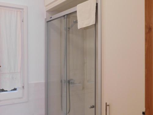 a shower with a glass door in a bathroom at Apart.Can Pons,con piscina, a 50 de la playa in Cala Galdana