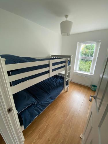 a bedroom with a bunk bed and a window at A Bigger Splash -Apartment Bangor West in Bangor