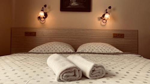 a bedroom with two towels on a bed at Penzión pri Kaštieli in Bratislava