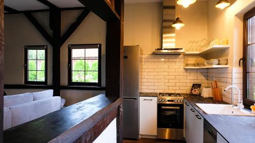 a kitchen with a counter and a sink and a stove at Stay At This Magnificent 100 Year Old Barn in Ruciane-Nida