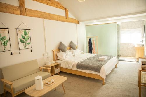 a bedroom with a bed and a couch at 雪湖轻奢民宿 Snowlake Inn in Shangri-La