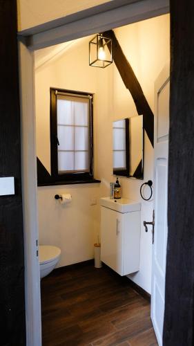 a bathroom with a toilet and a window at Stay At This Magnificent 100 Year Old Barn in Ruciane-Nida