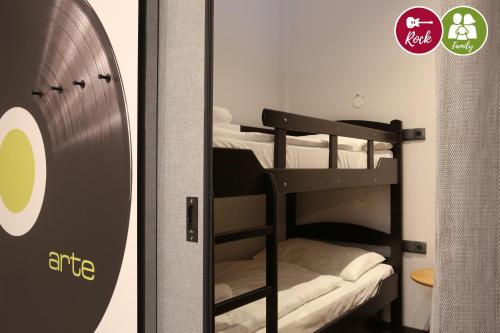 a room with bunk beds and a door with a window at arte Hotel Wien Stadthalle in Vienna