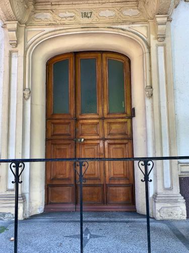 a large wooden door in the front of a building at Théâtre Sinne Luxury Apartement in Mulhouse