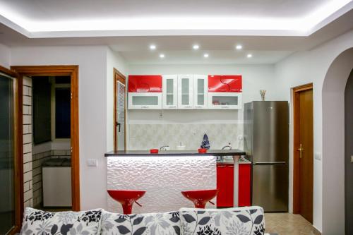 a kitchen with red and white cabinets and a counter at Silver in Žarkovo