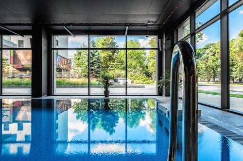 a swimming pool in a house with windows at PLATiNIUM RESIDENCE&SPA BASEN-SAUNA "BEST VIEW" CENTER in Lublin