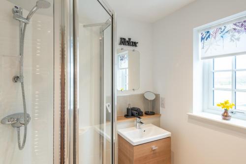 a bathroom with a shower and a sink at Stylish & Modern Apartment in Inverness