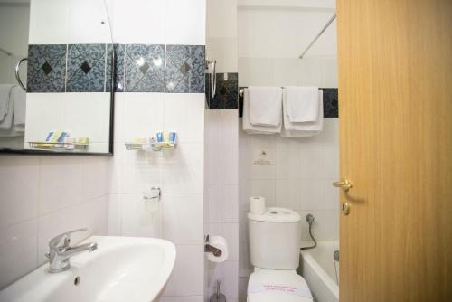 a bathroom with a toilet and a sink at Tzaki hotel & restaurant Patras in Patra