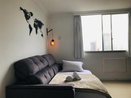 a bedroom with a couch with a world map on the wall at 703 · Apto inteiro Morumbi 703 ( 5 min-Hosp Einstein) in Sao Paulo