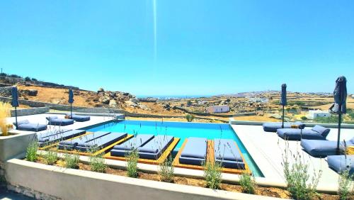 a swimming pool with a view of the ocean at Privilege houses Mykonos in Mýkonos City