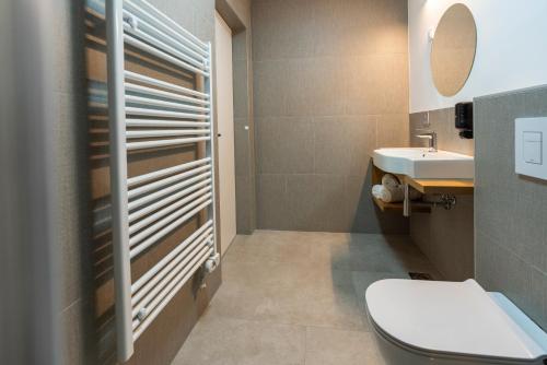 a bathroom with a toilet and a sink at Guesthouse & Camping Danica Bohinj in Bohinj