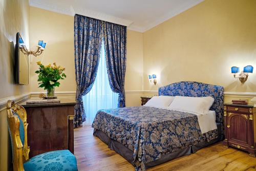 a hotel room with a bed and a window at Frezza Apartment - Alta Luxury Apartments in Rome