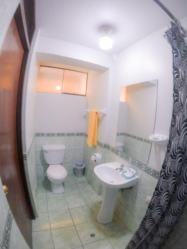 a bathroom with a toilet and a sink at Machu Picchu Land in Machu Picchu