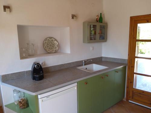 a kitchen with a sink and a counter top at House on Lesbos, Greece in Ypsilométopon