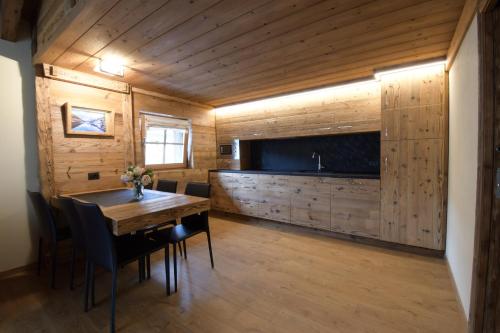 a dining room with a table and a television at Chalet Jolie in Livigno