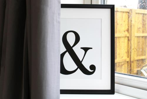 a picture of a letter k in a frame next to a window at Didcot - Private Flat with Garden & Parking 07 in Didcot